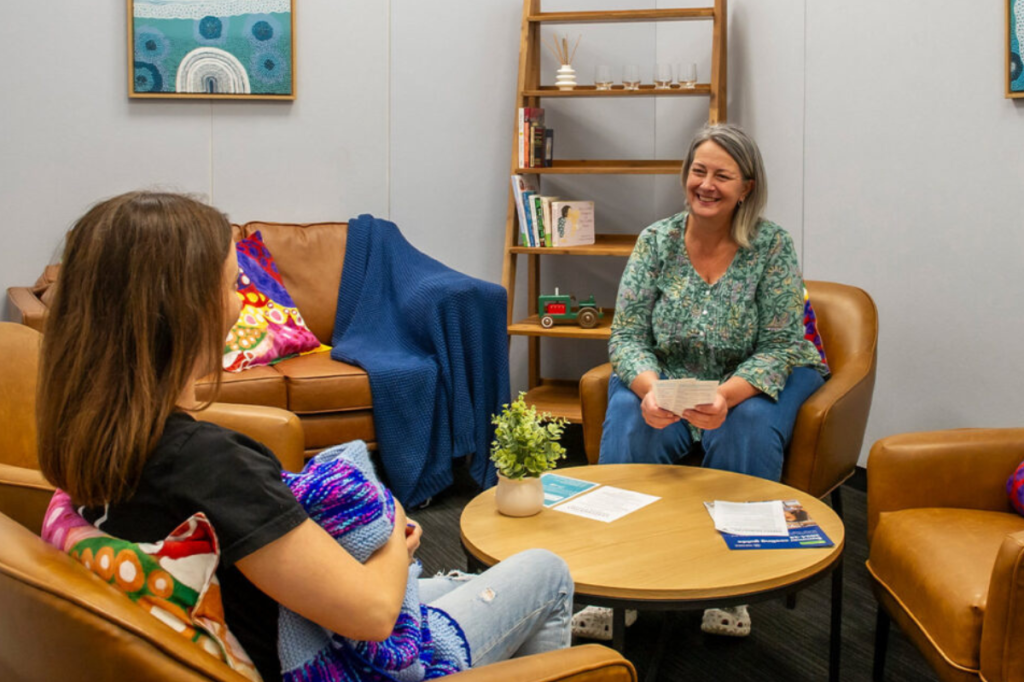 young person speaking with financial advisor in office
