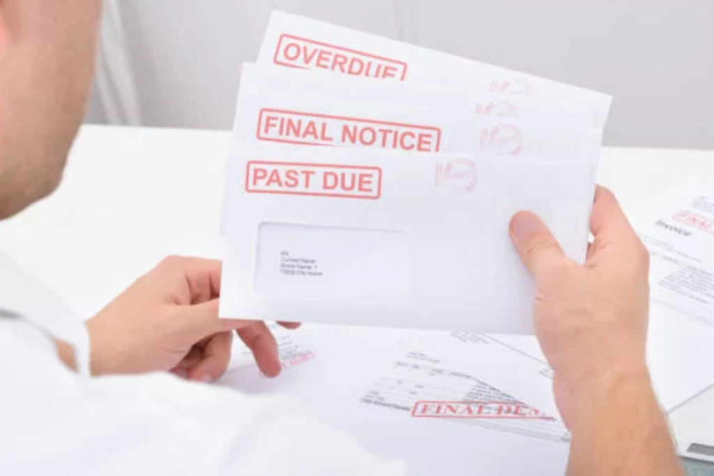 stack of unpaid bills on table