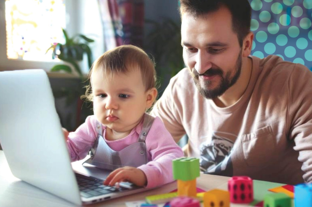 father and baby looking at a computer screen during an Inklings telehealth session