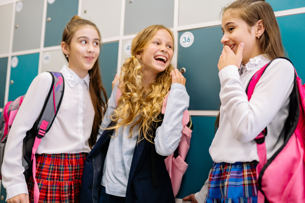 School girls laughing and talking together.