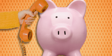 piggy bank with large phone pressed to its ear by a hand