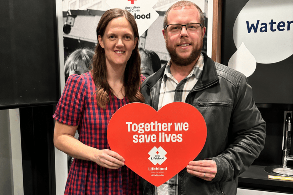 Alissa and Doug with a heart shaped sign saying Together we save lives