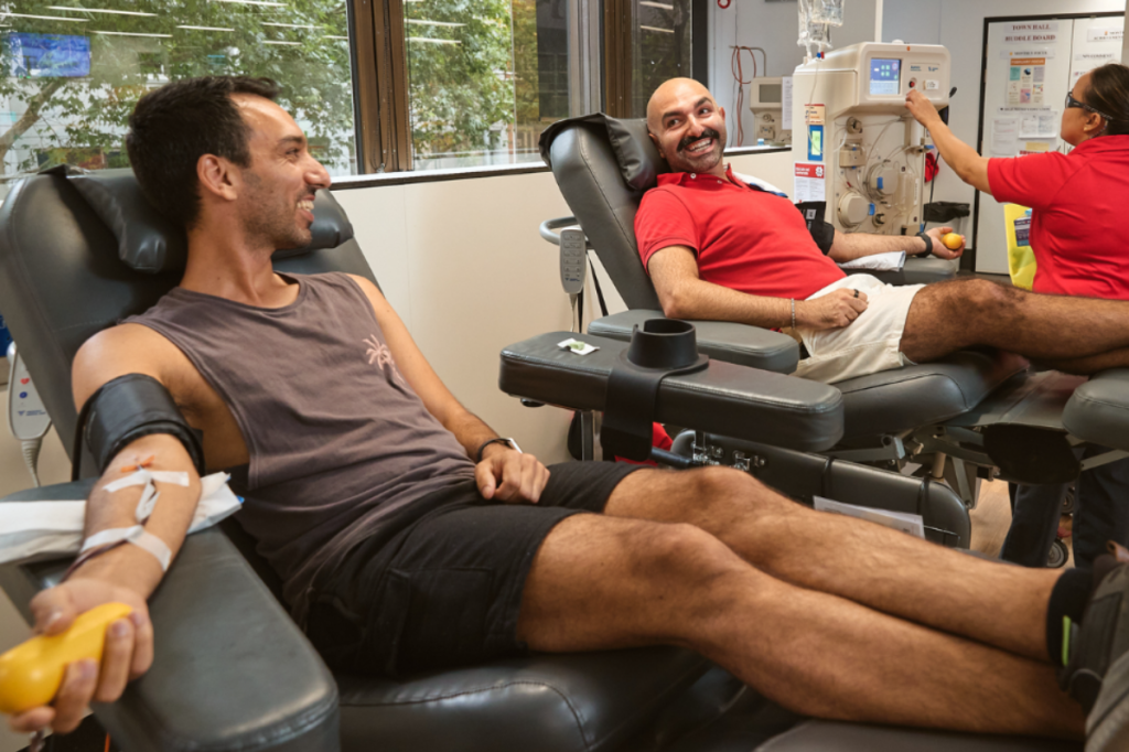 A male couple donating blood together.