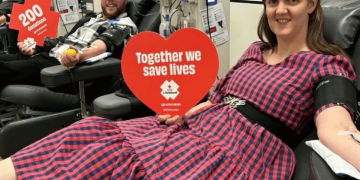 Alissa and Doug celebrating donation milestones at a Lifeblood donor centre