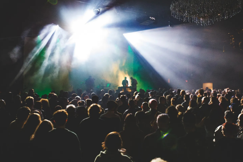 Crowd of dancing people enjoying Unsound, a music festival that's part of Illuminate Adelaide.