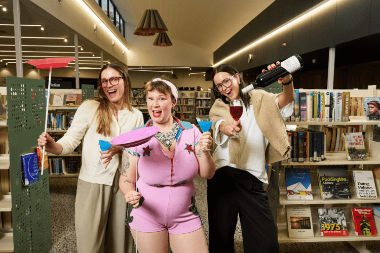 Erin Sundstrom, Lucy Frost and Kameron Bazzo learning to juggle while enjoying cocktails at a South Australian library