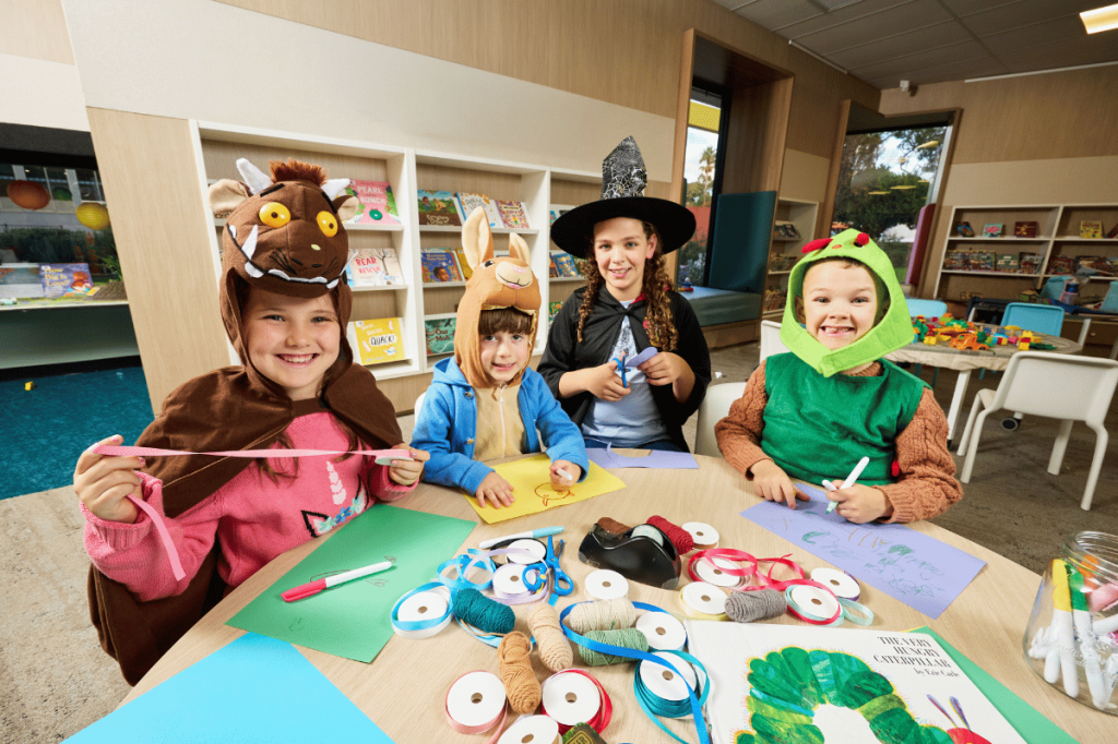 Children in costumes doing craft at an Adelaide library