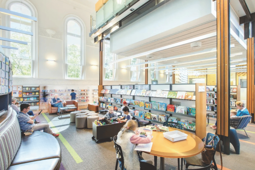 A library in Adelaide with people sitting, relaxing, reading and using their computers.